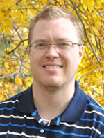 Middle aged man wearing a blue shirt.
