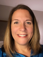 Middle aged woman wearing a blue shirt. 