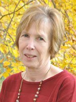 Middle aged woman wearing a red shirt.
