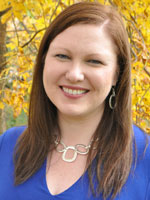 Middle aged woman wearing a dark blue shirt.