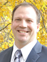 Middle aged man wearing a grey suit