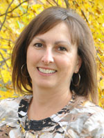 Middle aged woman wearing a colorful shirt. 