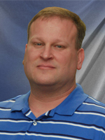 Middle aged man wearing a blue shirt. 