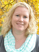 Woman with blond hair wearing a grey shirt.