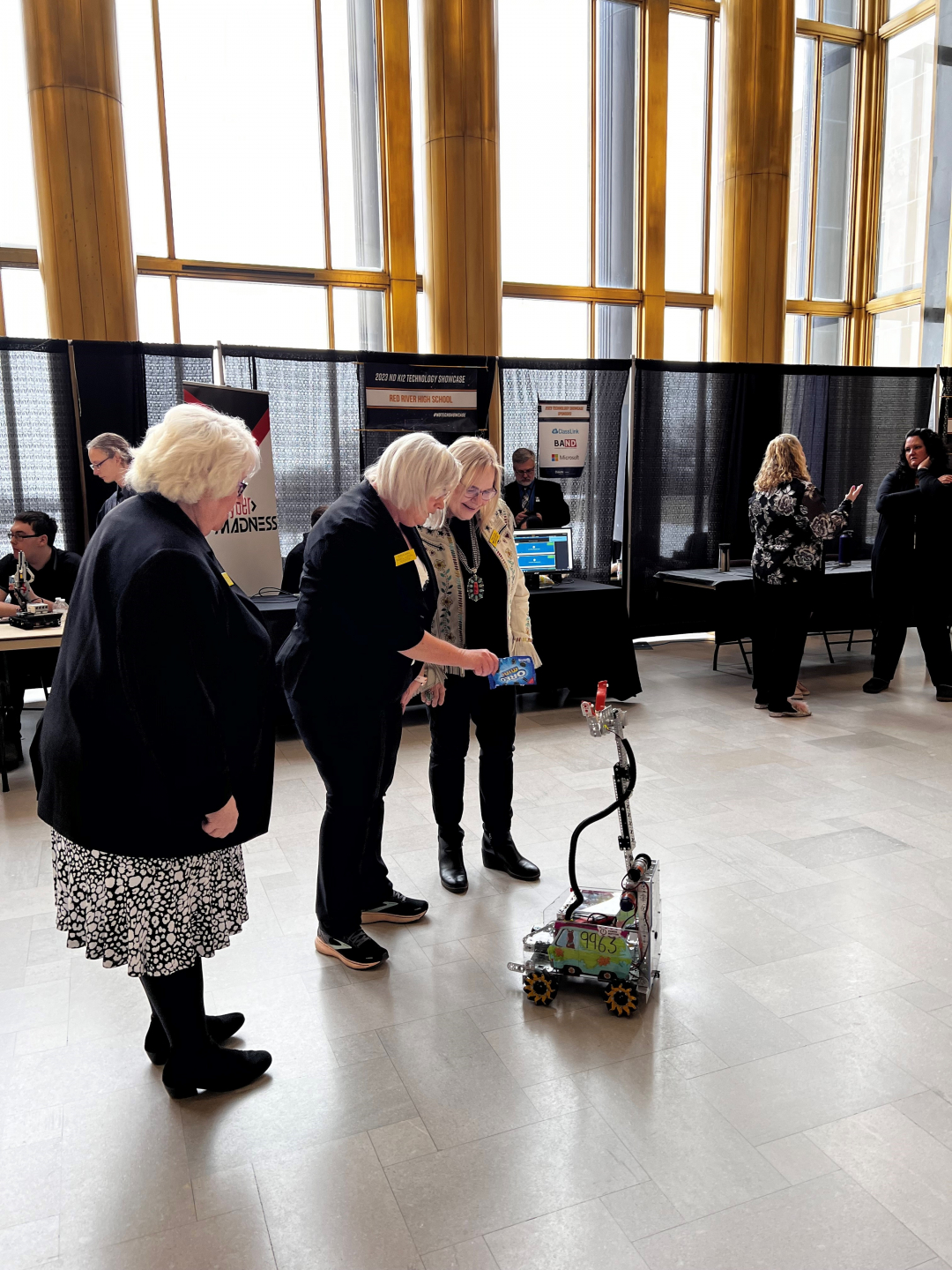 robot gives a package of cookies to a group watching the presentation